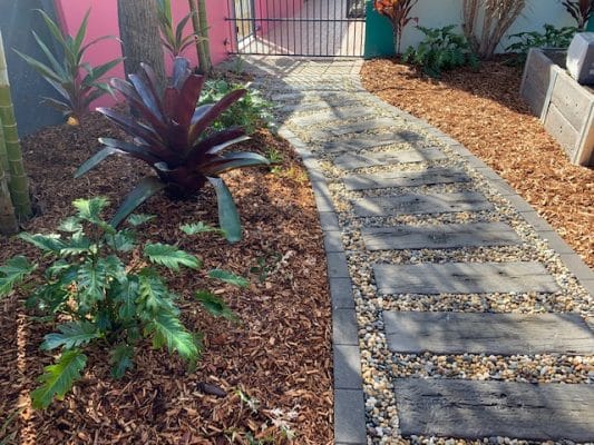 Garden Design Brisbane - Bromeliad with xanadu ceside meandering timber stone path