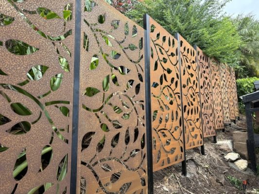 Corten steel privacy screens, fitted to black powder coated galvanised steel posts in Brisbane landscaping project